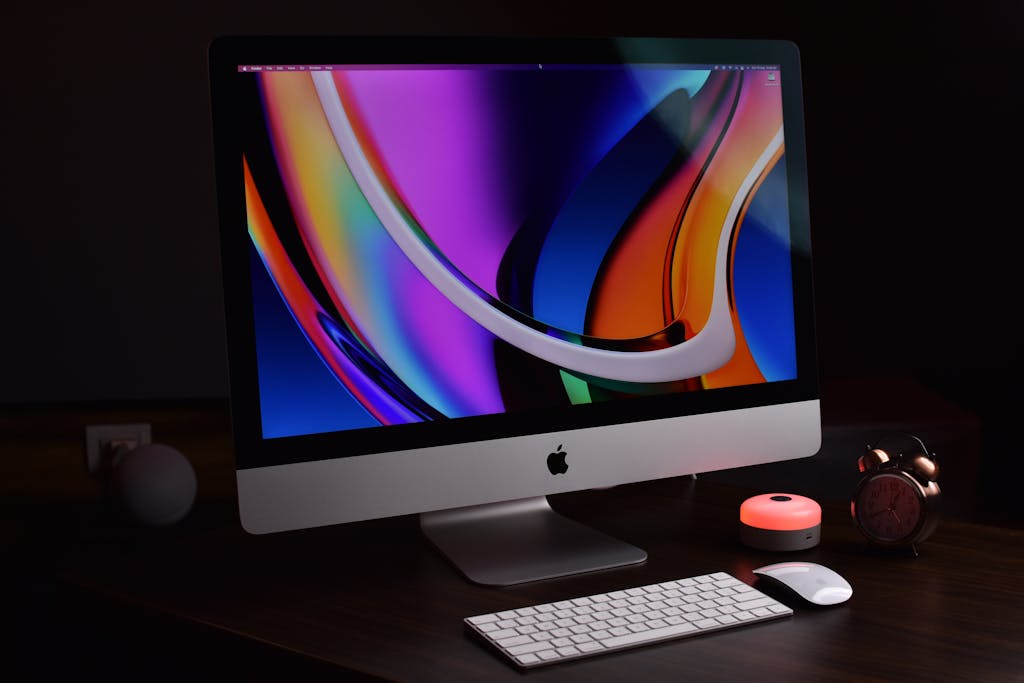 Modern Apple desktop setup with vibrant display and accessories, perfect for tech-savvy professionals.